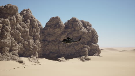 military helicopter flying over desert landscape