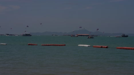 los turistas disfrutan de la diversión del parapente en pattaya, tailandia