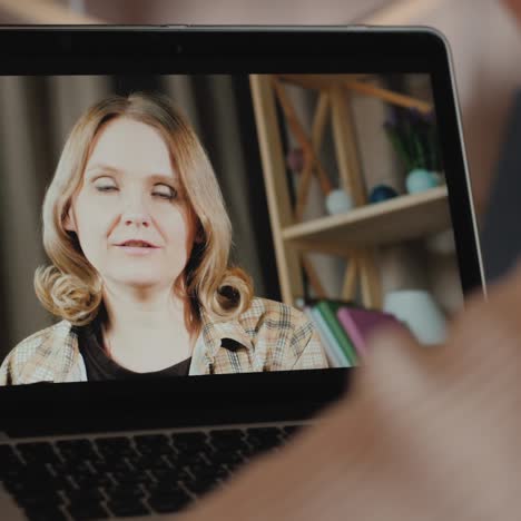 a woman communicates with a friend via video call