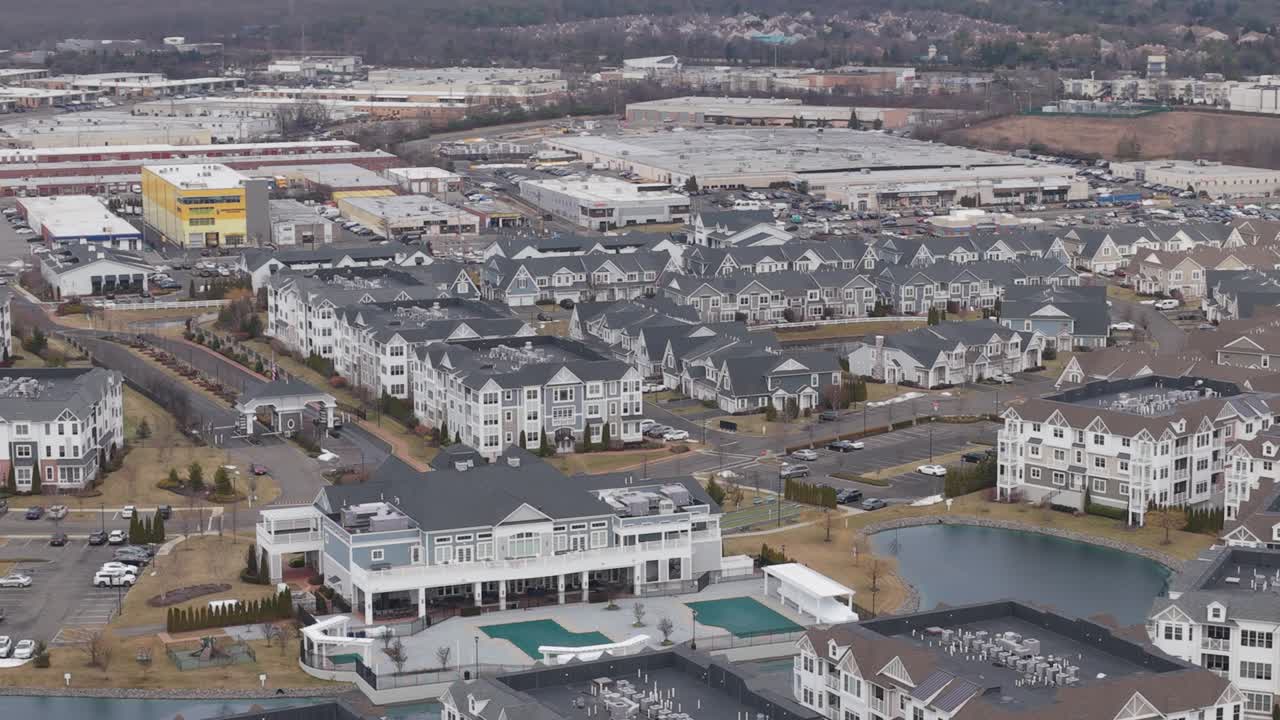 Holbrook new york suburban community with identical houses and apartment buildings. Modern residential complex featuring a clubhouse, pool, and small lake. In longisland