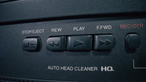 Classic-VHS's-play-button-is-pressed-by-a-man's-hand