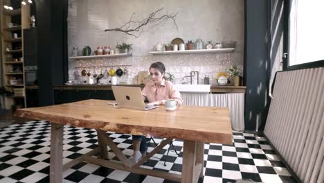 woman working from home in a cozy kitchen