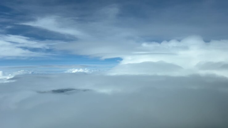 Immersive Pilot POV shot from a jet flying through a stormy sky plenty of clouds