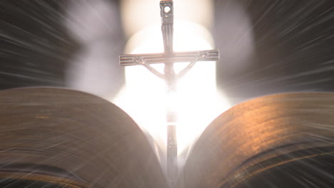 animation of christian cross with bible on glowing background