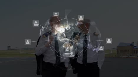 network of profile icons on globe over two caucasian pilots talking to each other at airport runway