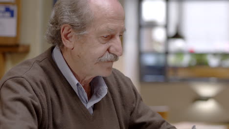 senior man having dinner in restaurant