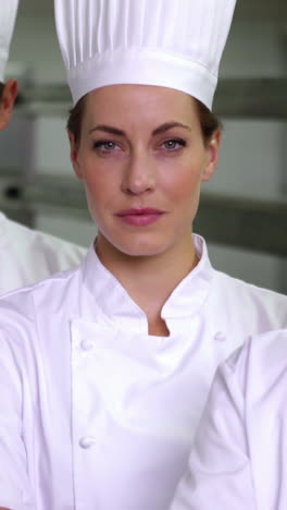 four stern chefs looking at camera with arms crossed