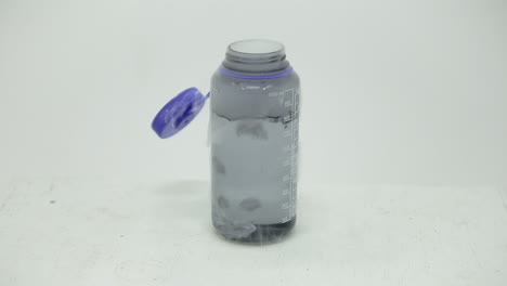 dry ice cube bubbling in a bottle