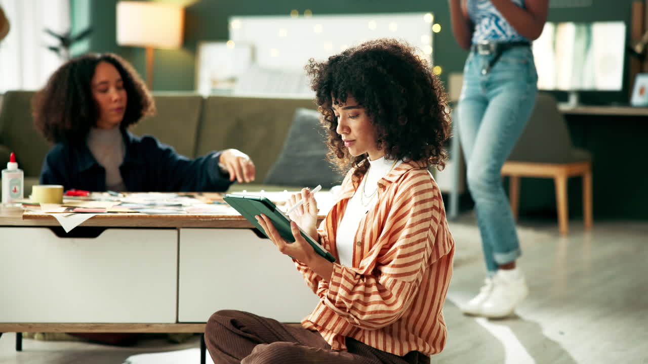 Women working on artwork on tablet