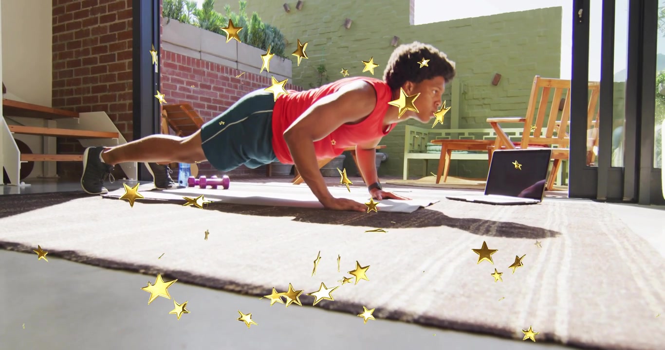 Male exerciser placing laptop, starting fitness pushups following coach with golden stars floating