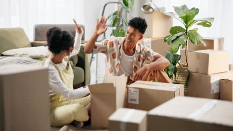Couple moving into new apartment surrounded by boxes