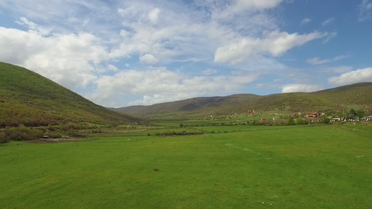 Low-Level Flying Drone On Filed and tilt-up to clouds. 50FPS