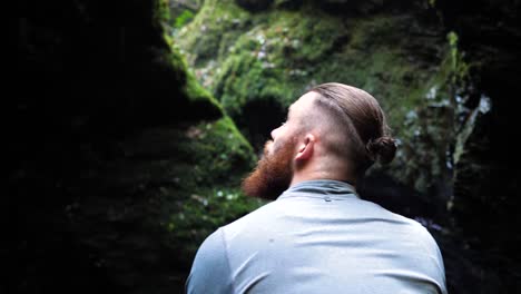 Young-man-looking-around-a-shadowy-forest