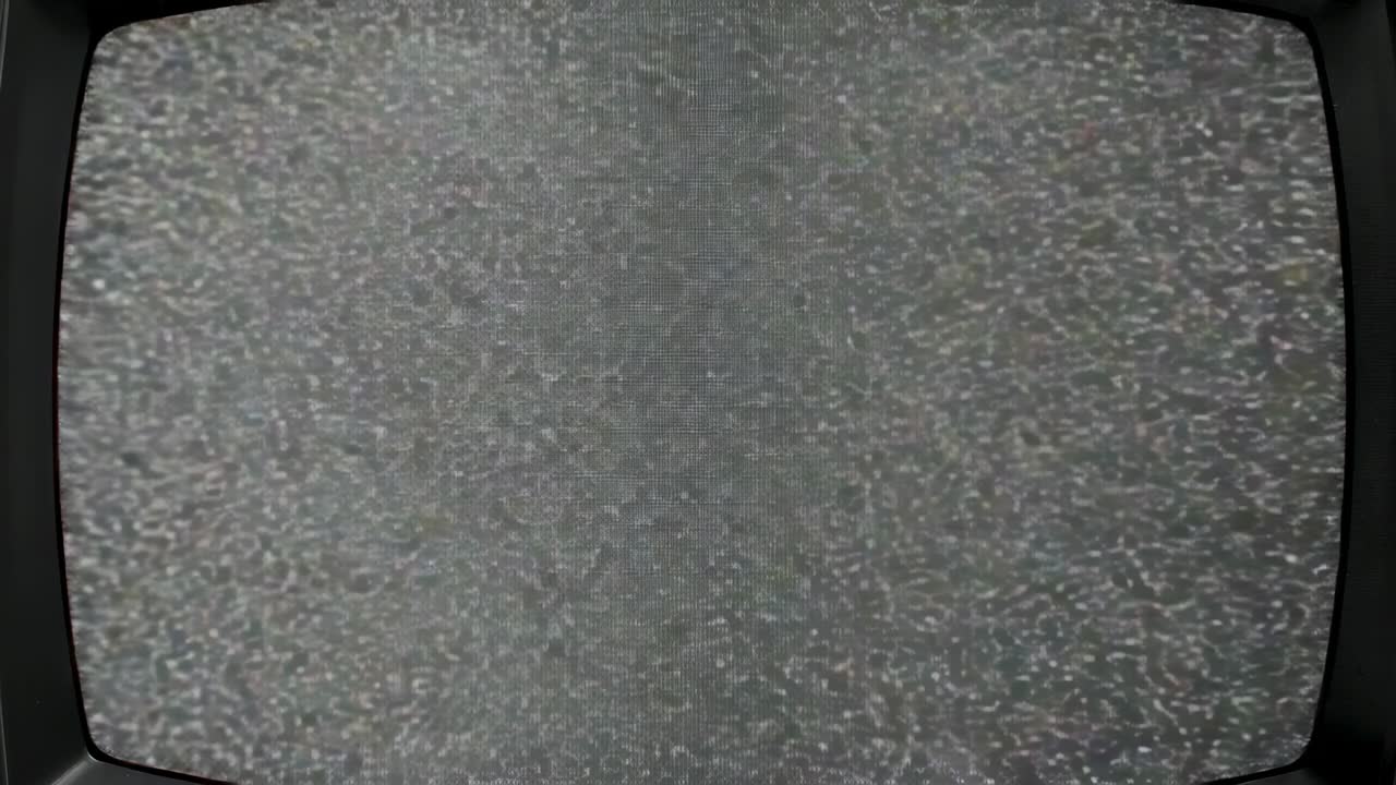 Static noise pattern flickering on CRT TV in closeup shot, creating eerie mood from signal loss