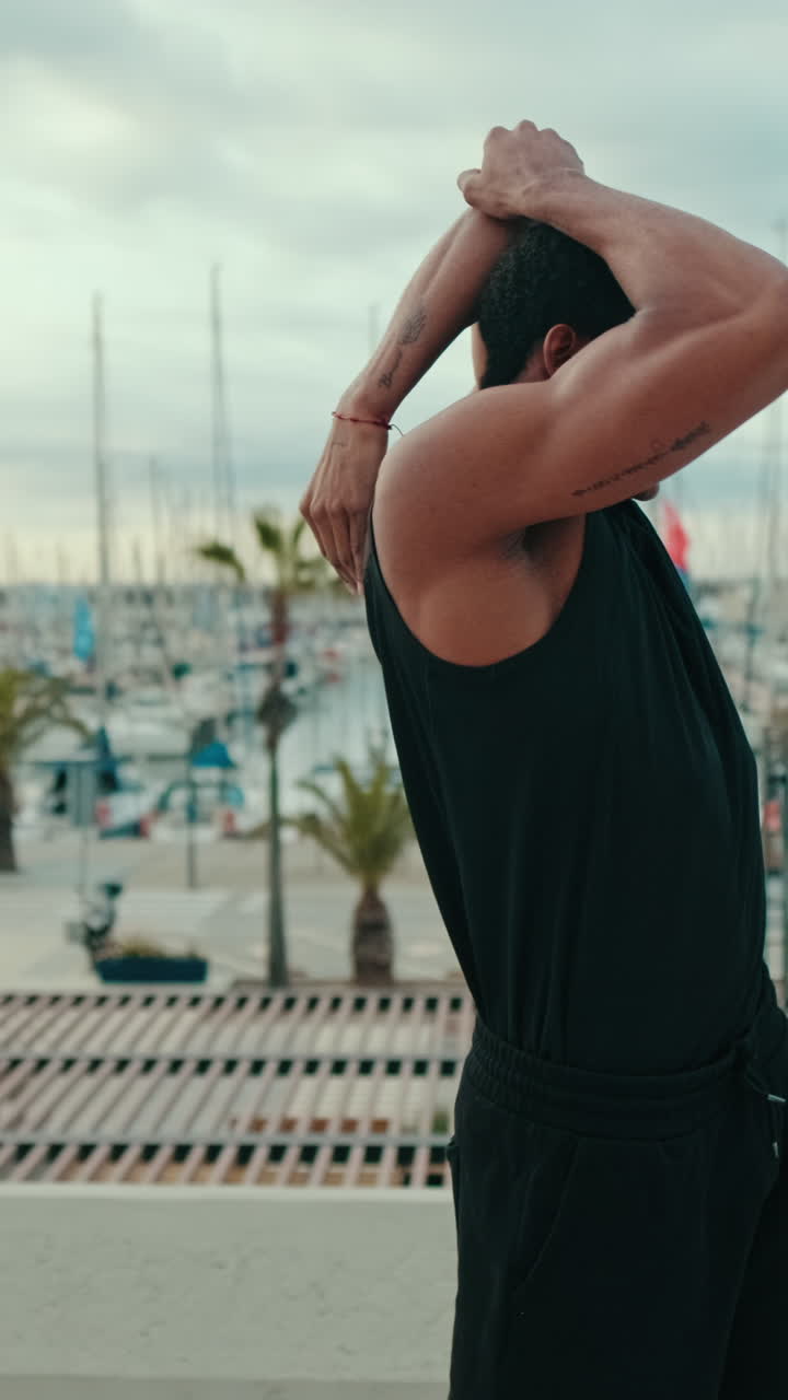 Young Man Stretching By The Marina