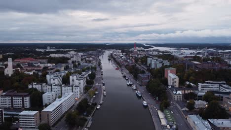 small river in a mid sized european city on a cloudy evening