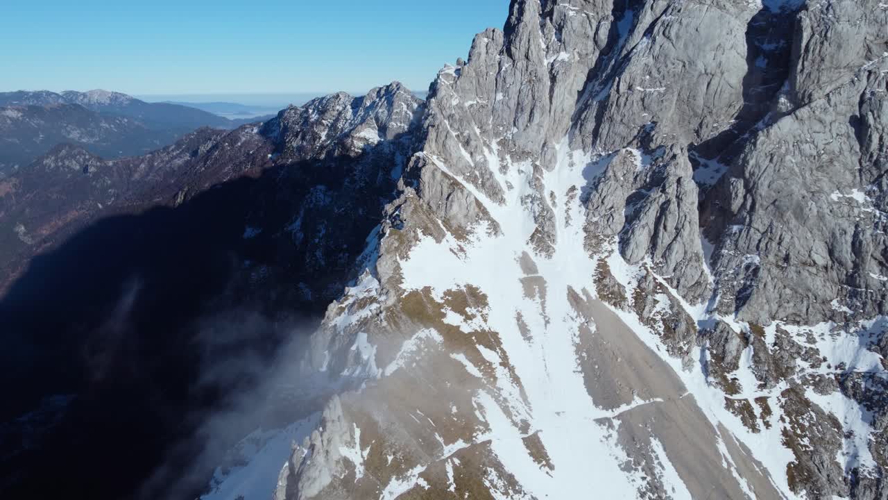 AERIAL Side Panning Shot of a Dramatic Mountain Ridge in Slovenian Alps in Winter
