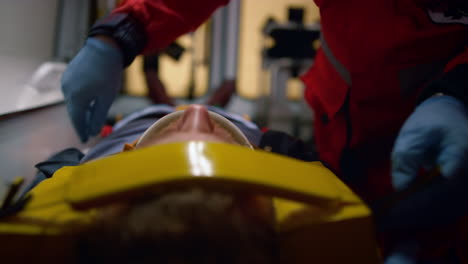 closeup medical workers hands taking care about patient in ambulance car