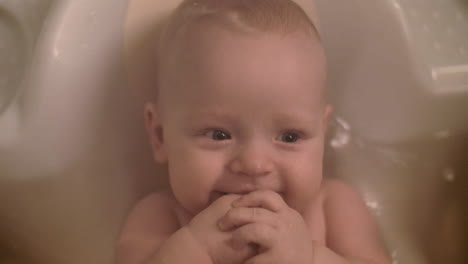 smiling baby girl bathing