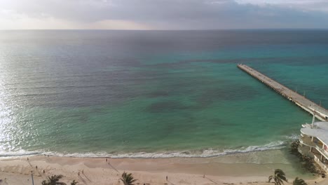 Aerial-view-of-visitors-in-Parque-Los-Fundadores-on-sea-coast-at-golden-hour