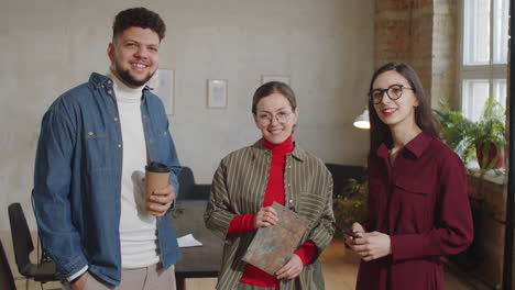 portrait of smiling colleagues at work in podcast recording studio