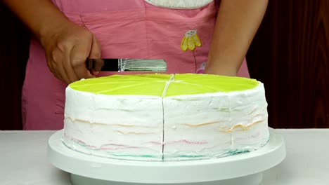 the chef is using a knife to cut a crepe cake into pieces.