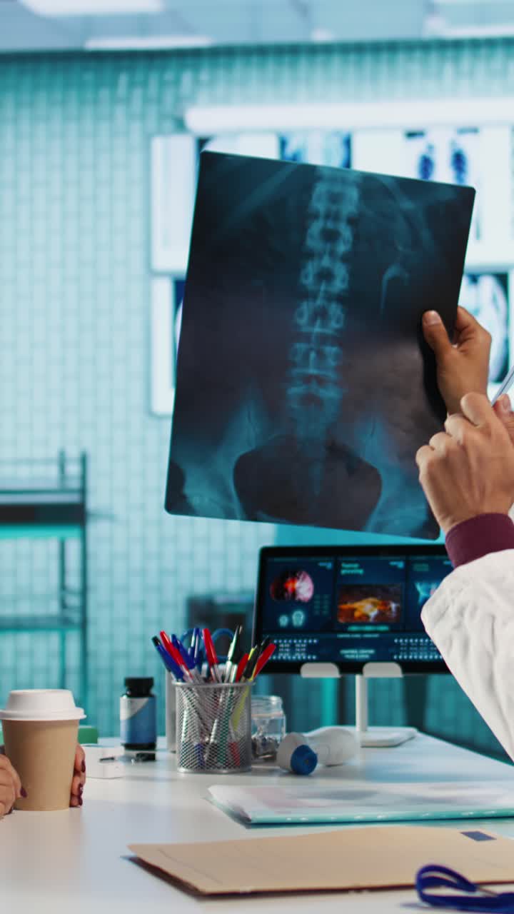 Doctor Explaining Spinal X-ray to Patient During Medical Consultation