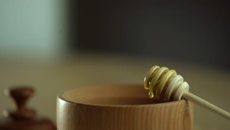 wooden bowl. close-up. healthy organic, wooden honey spoon, closeup.