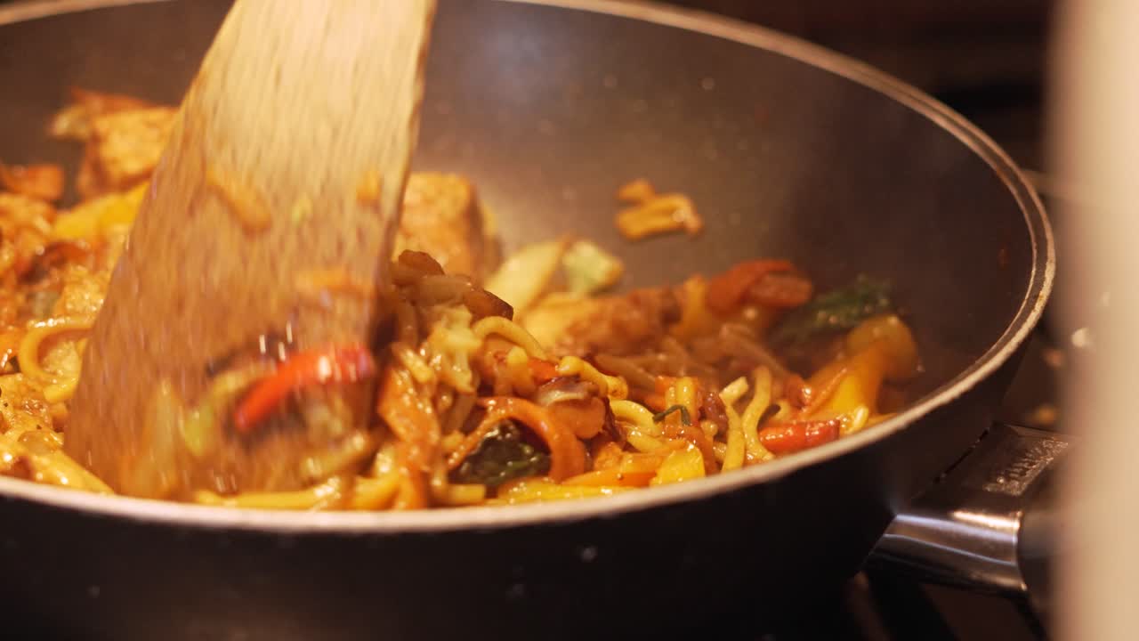 Slow Motion of Tofu Vegetable Stir Fry Stirred and Cooked by Chef in Hot Gas Wok