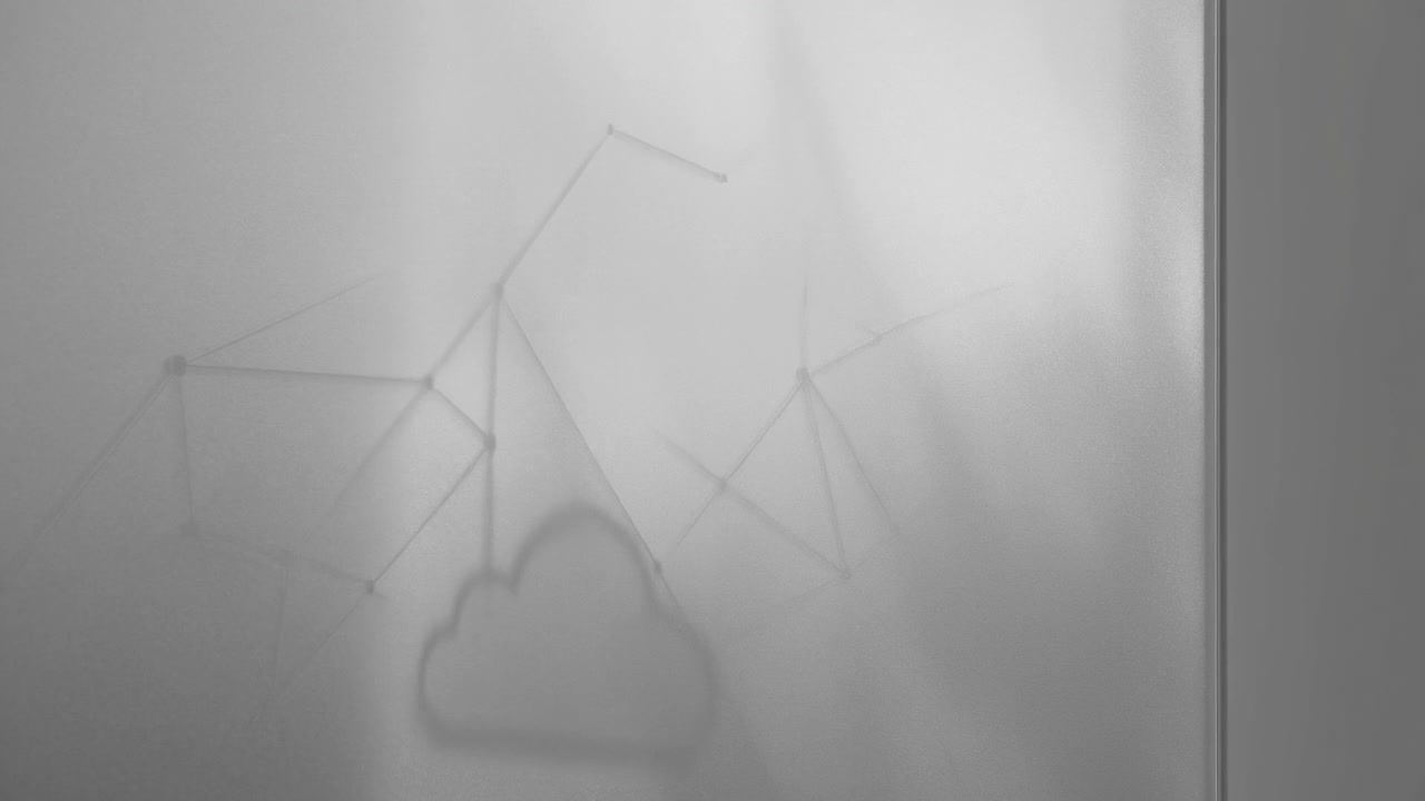 Cloud shaped shadow drifts across textured frosted glass while faint geometric armature shadows appear above and beside it, creating soft layered abstract interior scene under diffuse light