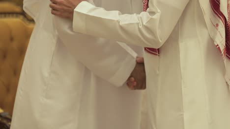 2 saudi men greeting at a wedding