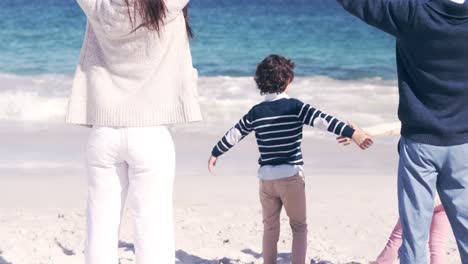 Young-family-with-hands-in-the-air