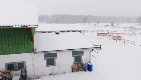 aerial view of a snowy farm with horses in northern germany