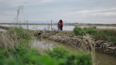 two women in a marsh landscape