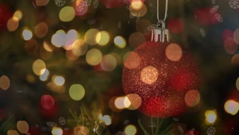 Animation-of-red-christmas-bauble-over-defocussed-flashing-fairy-lights