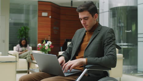 Businessman in Wheelchair Using Laptop