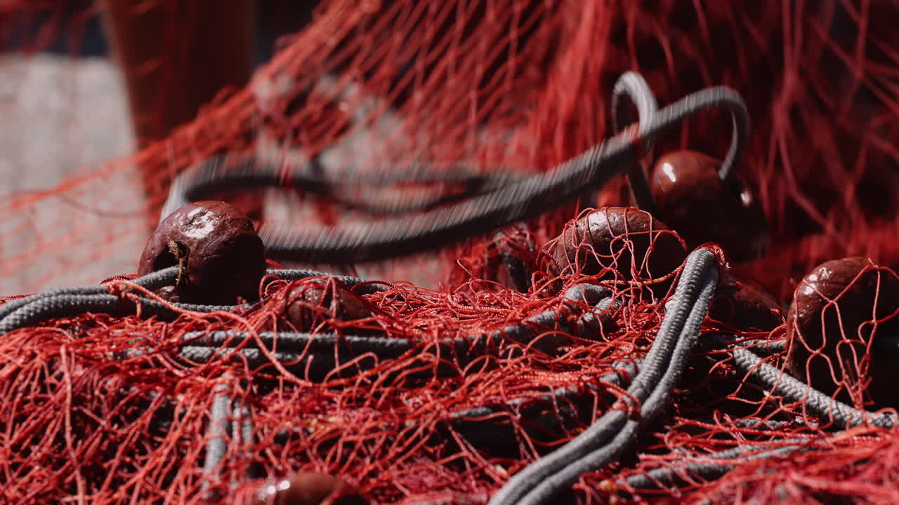 Fisherman works with fishing net. Sicily, Italy