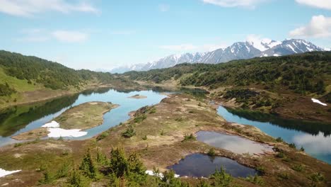 drone shot of a man walking towards isolated lakes in the alaskan backcountry