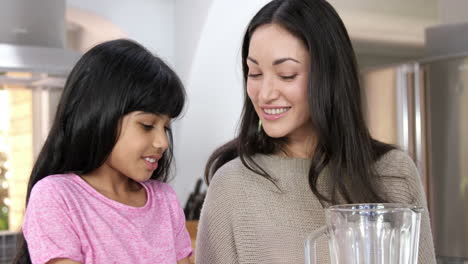 Mother-and-daughter-making-smoothies-