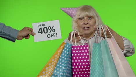 Inscription-Up-To-40-Percent-Off-appears-next-to-grandmother.-Woman-celebrating-with-shopping-bags