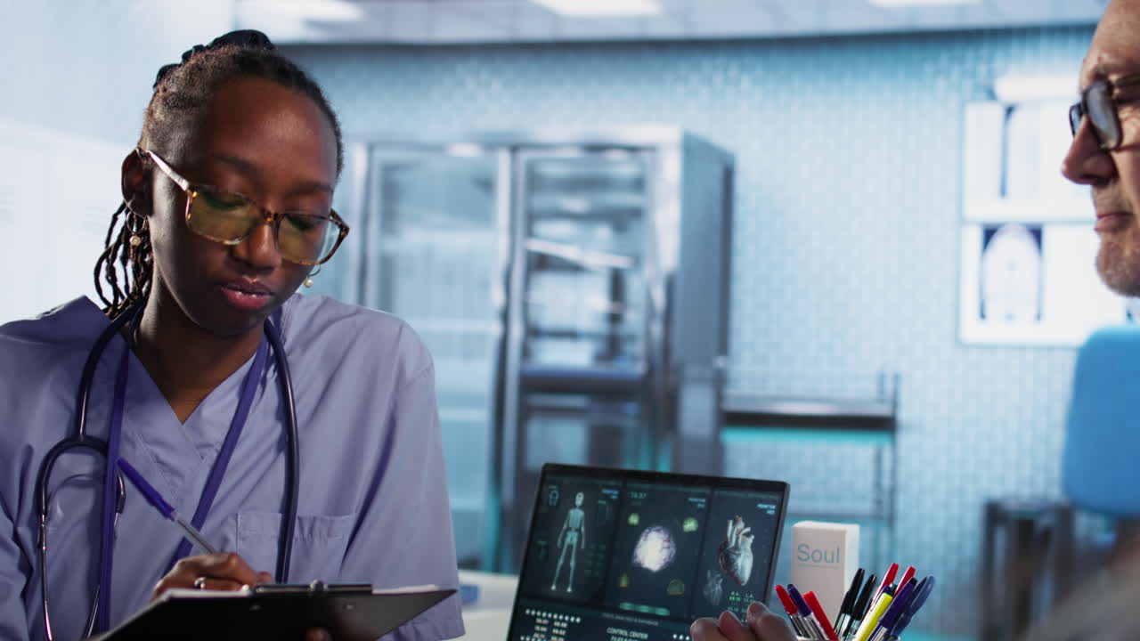 Vertical Video African american nurse evaluating lab test results and creating a recovery plan
