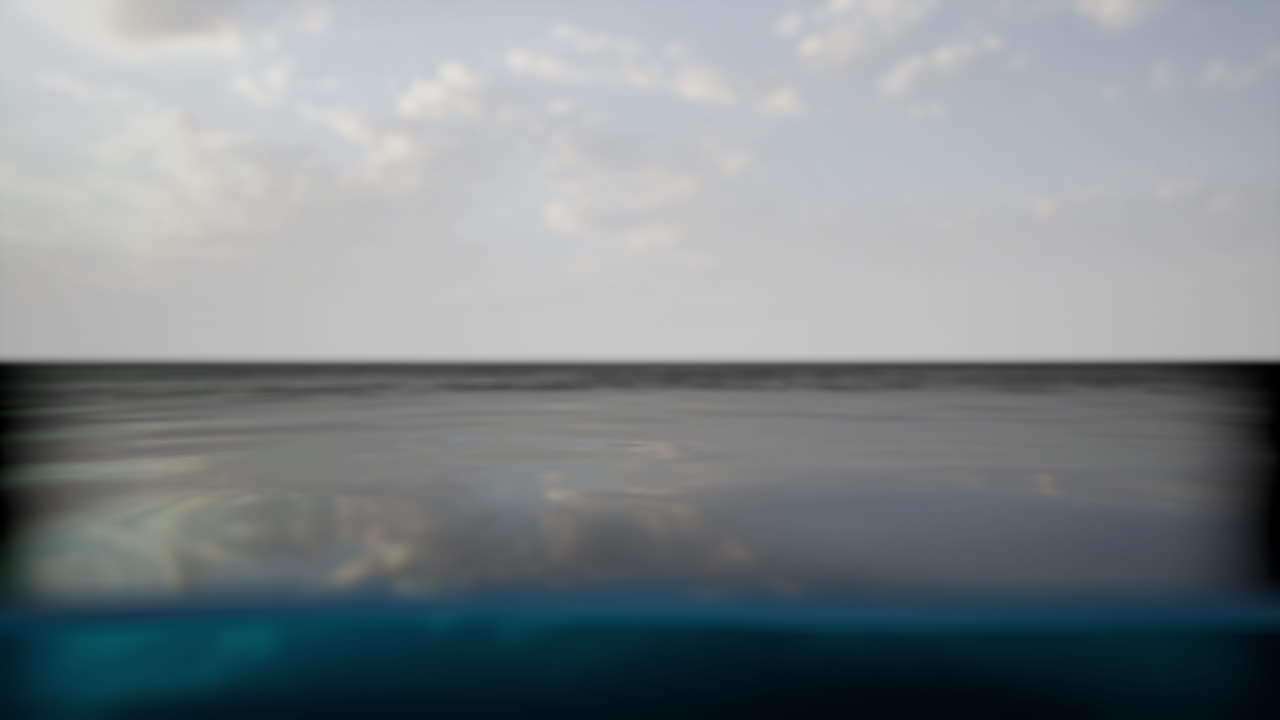 Calm ocean water with clouds in the sky