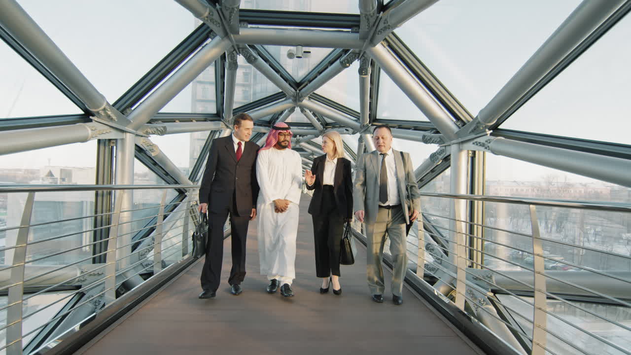 Diverse Business Team Walking Along Glass Bridge