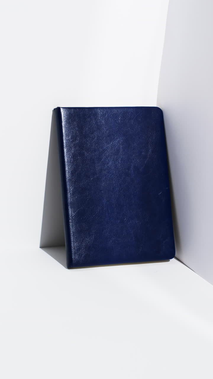 Video of book in blue cover with copy space on white background
