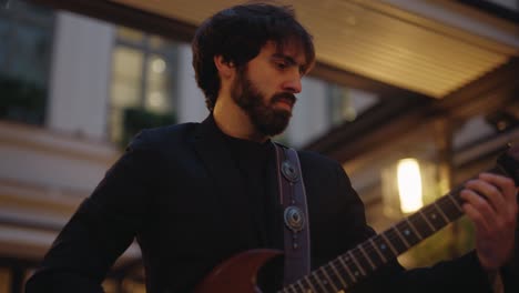 closeup view featuring band member playing electric guitar at a party in paris, france.