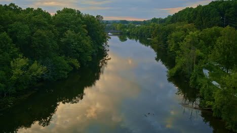 aerial view of the huron river in ann arbor, michigan, filmed by a slow-moving drone in summer.