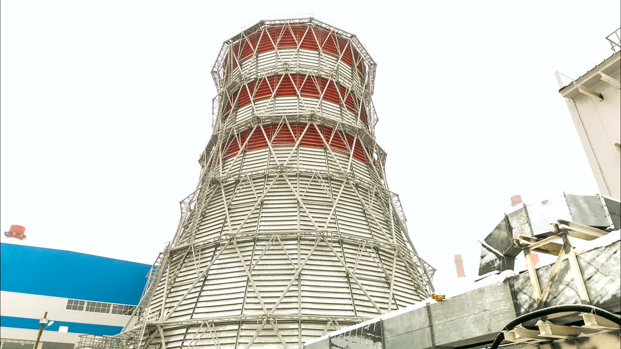 time lapse motion along refinery plant area to large tower
