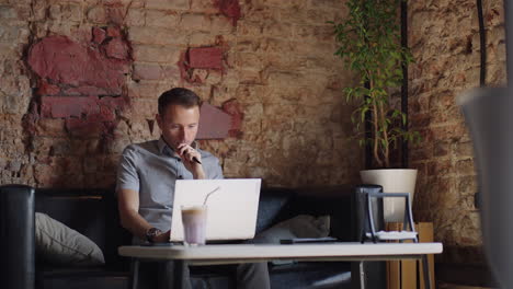 Thoughtful-serious-young-man-student-writer-sit-at-home-office-desk-with-laptop-thinking-of-inspiration-search-problem-solution-ideas-lost-in-thoughts-concept-dreaming-looking-away