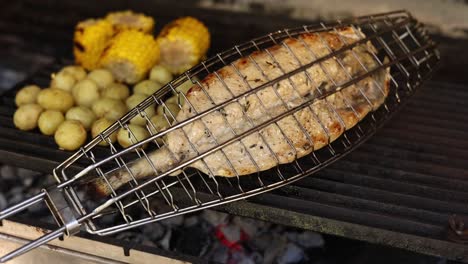 grilled fish and vegetables on a barbecue grill