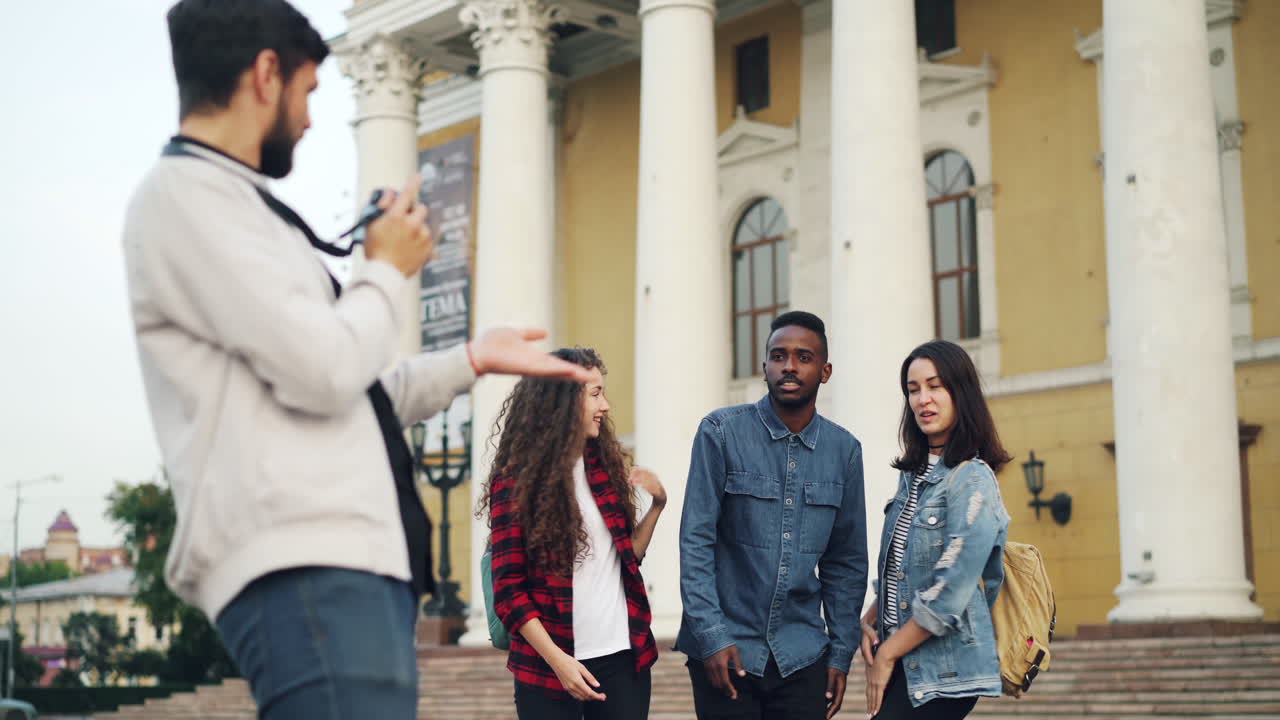 Friends posing for a photo in front of a building